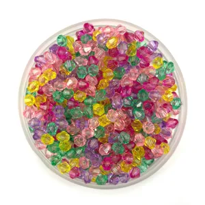 Close-up detail of colorful acrylic gemstone beads in a round transparent tray, ideal for DIY crafts.