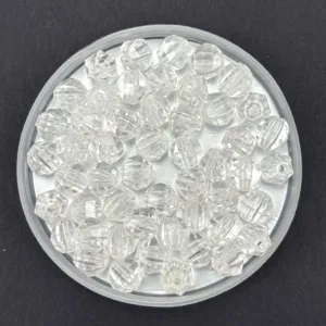 Close-up detail of clear acrylic faceted rhombus lantern loose beads for DIY jewelry crafts.