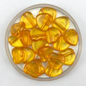 Detailed closeup of 20mm acrylic heart beads with horizontal holes, ideal for DIY jewelry making.