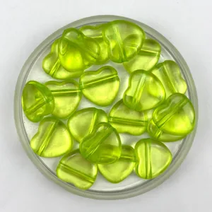 Transparent green heart-shaped acrylic beads with horizontal hole for DIY jewelry making.