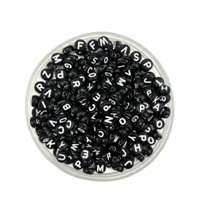Close-up detail of black acrylic alphabet letter beads, perfect for DIY jewelry making.