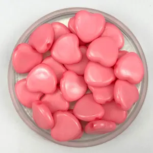 Pink acrylic heart beads with horizontal holes, perfect for DIY jewelry making and kids crafts.