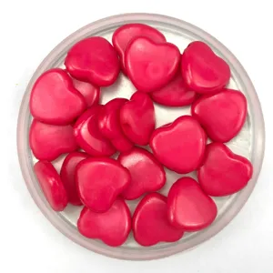 Detailed close-up of pink heart-shaped acrylic beads, perfect for DIY jewelry making crafts.