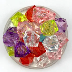 Close-up detail of colorful acrylic crystal ice cubes and crushed stones for photography props.