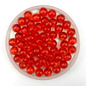 Close-up detail of red transparent acrylic round beads for DIY handmade jewelry crafts.