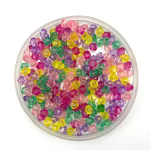 Close-up of colorful faceted acrylic bicone beads in clear tray, perfect for DIY jewelry craft.