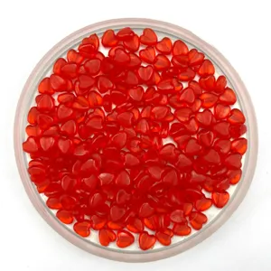 Red plastic heart beads detail shot showing shape for DIY crafts and jewelry making