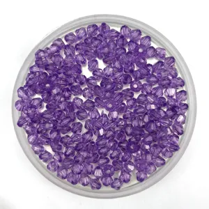 Detailed close-up of purple acrylic bicone beads for DIY jewelry making and curtain crafting.