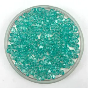 Turquoise faceted bicone crystal beads close up, ideal for handmade DIY jewelry crafting.