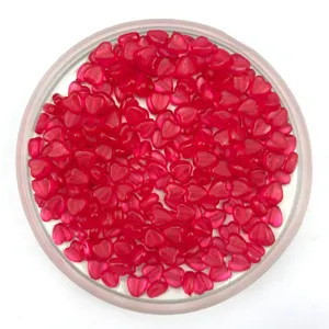 Detail view of 6mm pink translucent heart-shaped plastic beads in a clear tray for DIY crafts.