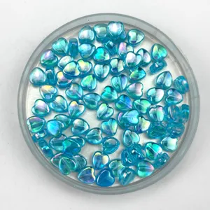 Detail view of blue acrylic heart-shaped AB color-plated loose beads for DIY handmade jewelry.