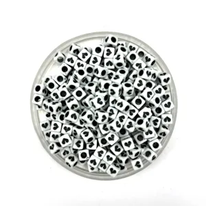 Close-up of square acrylic beads with black heart patterns, perfect for DIY jewelry crafting.