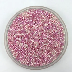 Close-up detail of 2-2.5mm non-porous pink and purple acrylic micro beads for DIY crafts.