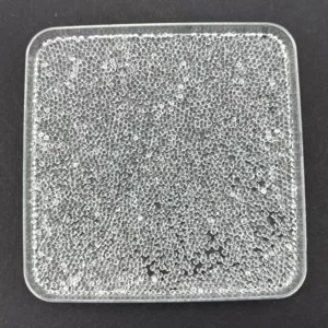 Clear transparent plastic micro beads detail shot, tiny round balls for DIY crafts part.