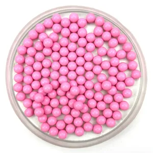 Close-up detail of solid pink acrylic round beads, smooth surface for DIY craft projects.