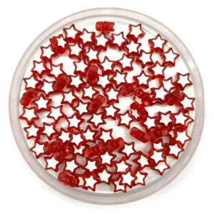 Close-up detail of red and white star-shaped acrylic loose beads for DIY jewelry making.