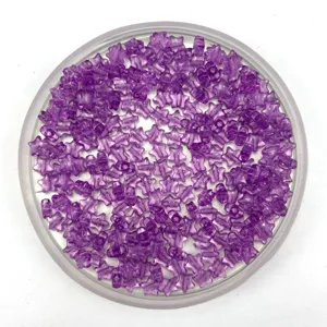 Close-up of purple transparent star acrylic beads in round tray for DIY jewelry making