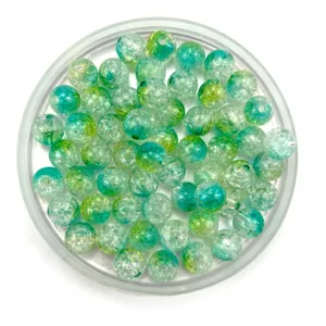 Close-up of vibrant blue and green crackle glass beads in a clear tray for DIY crafts.