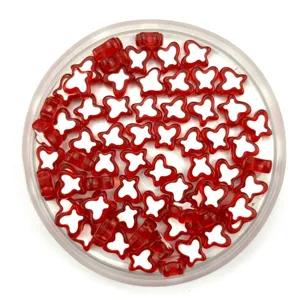 Detailed close-up of red and white acrylic butterfly beads for DIY jewelry crafting.
