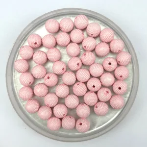 Detailed view of 8mm pink acrylic textured dot beads, perfect for DIY jewelry and crafts.