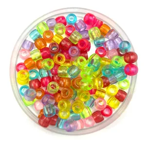 Close-up detail view of colorful plastic pony beads with large holes, candy color craft style.