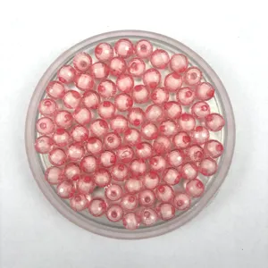 Close-up of pink transparent acrylic faceted earth beads, perfect for DIY jewelry making crafts.