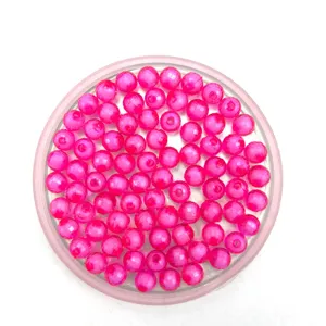 Detailed view of pink faceted transparent acrylic earth beads for DIY jewelry making crafts.