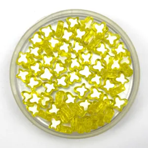 Close-up view of yellow and white acrylic butterfly beads for DIY jewelry design and phone chains.
