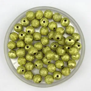 Detail shot of gold frosted acrylic round beads with wrinkled texture, perfect for DIY jewelry making.