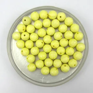 Close-up details of 8mm yellow acrylic bayberry beads with dotted stripe texture for DIY jewelry.