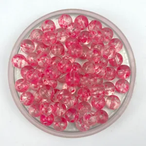 Acrylic crackle bead detail view, pink splatter design transparent DIY bracelet bead for jewelry crafting.