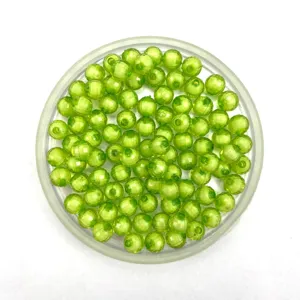 Close-up detail of transparent green acrylic bead-in-bead, perfect for DIY handmade jewelry.