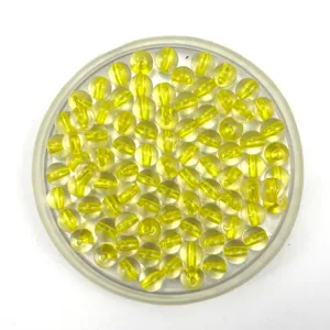 Close-up view of yellow inner-core transparent acrylic beads neatly arranged in a clear tray detail.