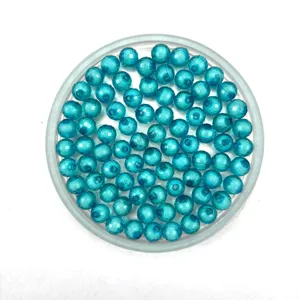 Close-up view of transparent blue acrylic beads arranged neatly for handmade jewelry making.