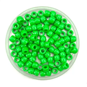 Green plastic barrel beads detail shot, smooth surface craft pony beads for hair braiding.