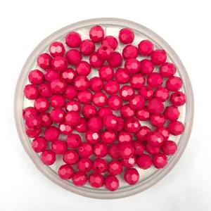 Close-up of vibrant pink faceted acrylic beads, perfect for DIY jewelry making and crafts.