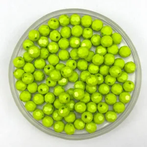 Detailed view of bright green faceted acrylic loose beads in a clear tray for DIY jewelry making.