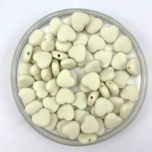 Detailed view of matte acrylic heart loose beads showing smooth surface and straight hole design.