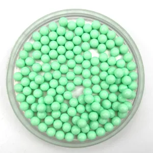 Close up product detail of light green solid round acrylic beads neatly displayed in tray.