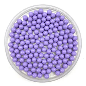 Close-up detail shot of solid purple round plastic craft beads displayed inside a clear tray.