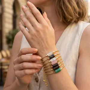 Detail view of a vintage natural stone beaded bracelet stack with adjustable chain.