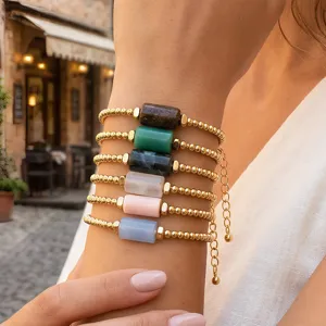 Natural stone cylindrical beaded stackable bracelet detail, vintage gold tone adjustable jewelry.