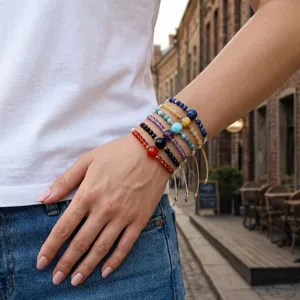 Close-up detail view of stacked gemstone planetary beaded bracelets worn on wrist, boho style.