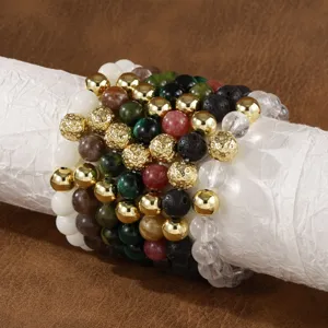 Detail view of layered natural gemstone and gold metal beaded bracelets set for men stylish.