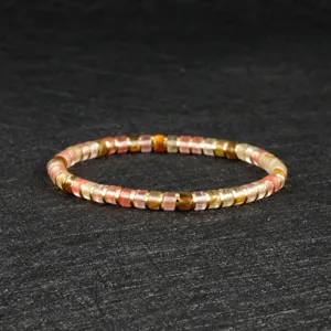 Delicate bohemian beaded bracelet featuring colorful crystal discs and chic gold spacers.