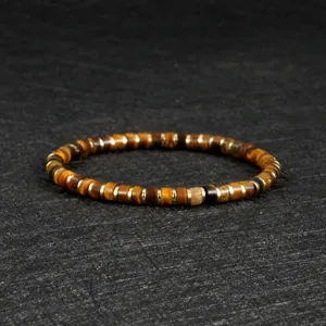 Detailed shot of bohemian style tiger eye stone and metal spacer beaded stretch bracelet.