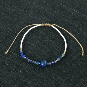 Handmade woven beaded bracelet detail, featuring blue stones and white Miyuki seed beads.