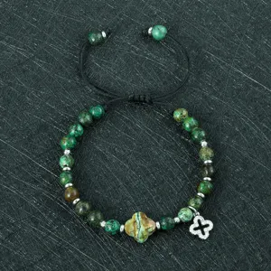 Gedetailleerd overzicht van een modieuze dames gevlochten klaverarmband met edelsteen kralen.