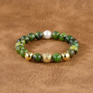 Close-up detail of the beaded bracelet featuring green gemstones, gold beads, and a central ball.