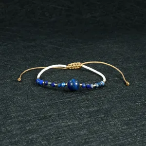 Handcrafted beaded bracelet detail featuring blue stones and adjustable cord for daily boho chic style.